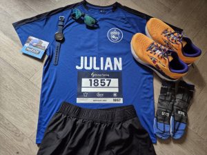 Race t shirt, race number, running shoes, running shorts laid out ready for running the great west run